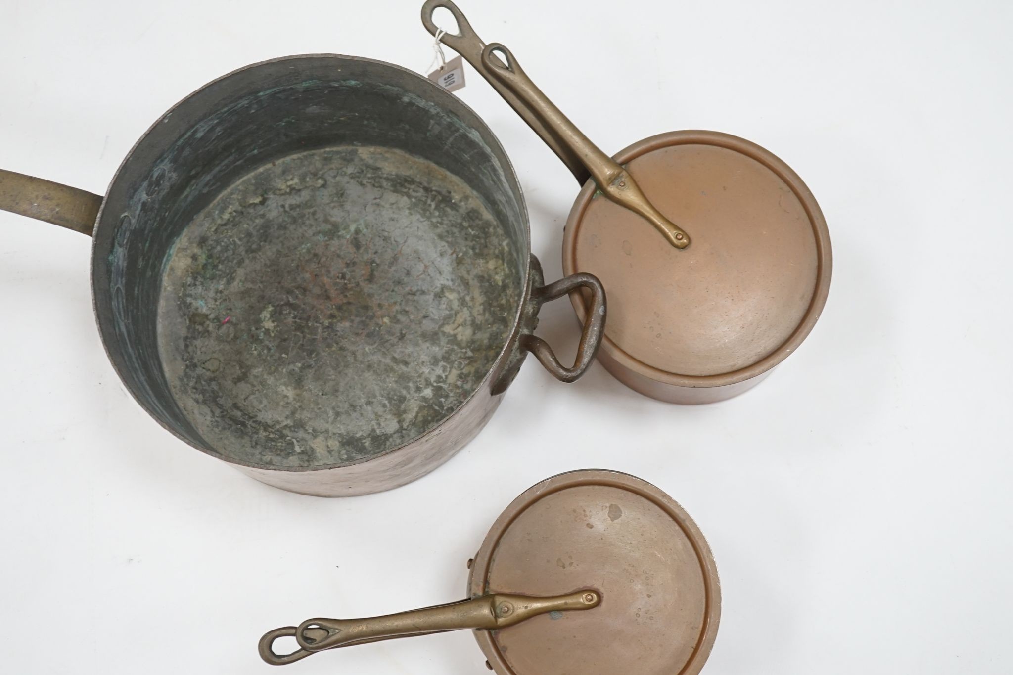 A group of three Jaeggi & Sons copper saucepans